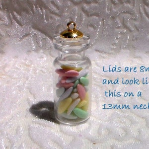 May include: A clear glass jar with a gold lid filled with pastel-colored candy. The lid is 8mm and fits on a 13mm neck. Lids are 8mm and look like this on a 13mm neck.