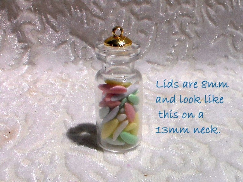 May include: A clear glass jar with a gold lid filled with pastel-colored candy. The lid is 8mm and fits on a 13mm neck. Lids are 8mm and look like this on a 13mm neck.