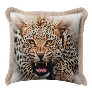 May include: Square decorative pillow featuring a close-up of a snarling leopard. The pillow has a beige border with a textured, furry appearance. The leopard's fur is tan with black spots, and its eyes are yellow.