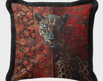 May include: Decorative throw pillow featuring a leopard with a spotted coat, set against a red and black patterned background. The pillow has a black fringe border, adding a touch of elegance to the design.