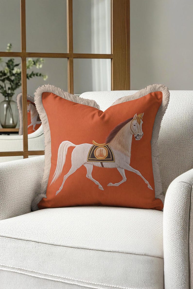 Add a layer of texture to your home with our Tasseled Cushion Case. The exquisite cream-colored fringes provide a sophisticated contrast to the bold orange base. Centered with a detailed horse illustration, this pillow cover brings a "Bohemian meets Traditional" vibe to any space. Perfect for layering on your sofa or bed, it offers both tactile comfort and high-end visual appeal. Upgrade your home textile collection with this fringed masterpiece.