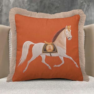 Bring the spirit of the ranch to your home with our Western-style Horse Pillow Cover. The earthy orange tones and detailed equestrian art fit perfectly with rustic furniture and leather sofas. The delicate fringe edges add an authentic, handmade feel that complements farmhouse aesthetics. Durable and stylish, this cushion case is the ultimate accessory for those who love country living and high-quality textile art.