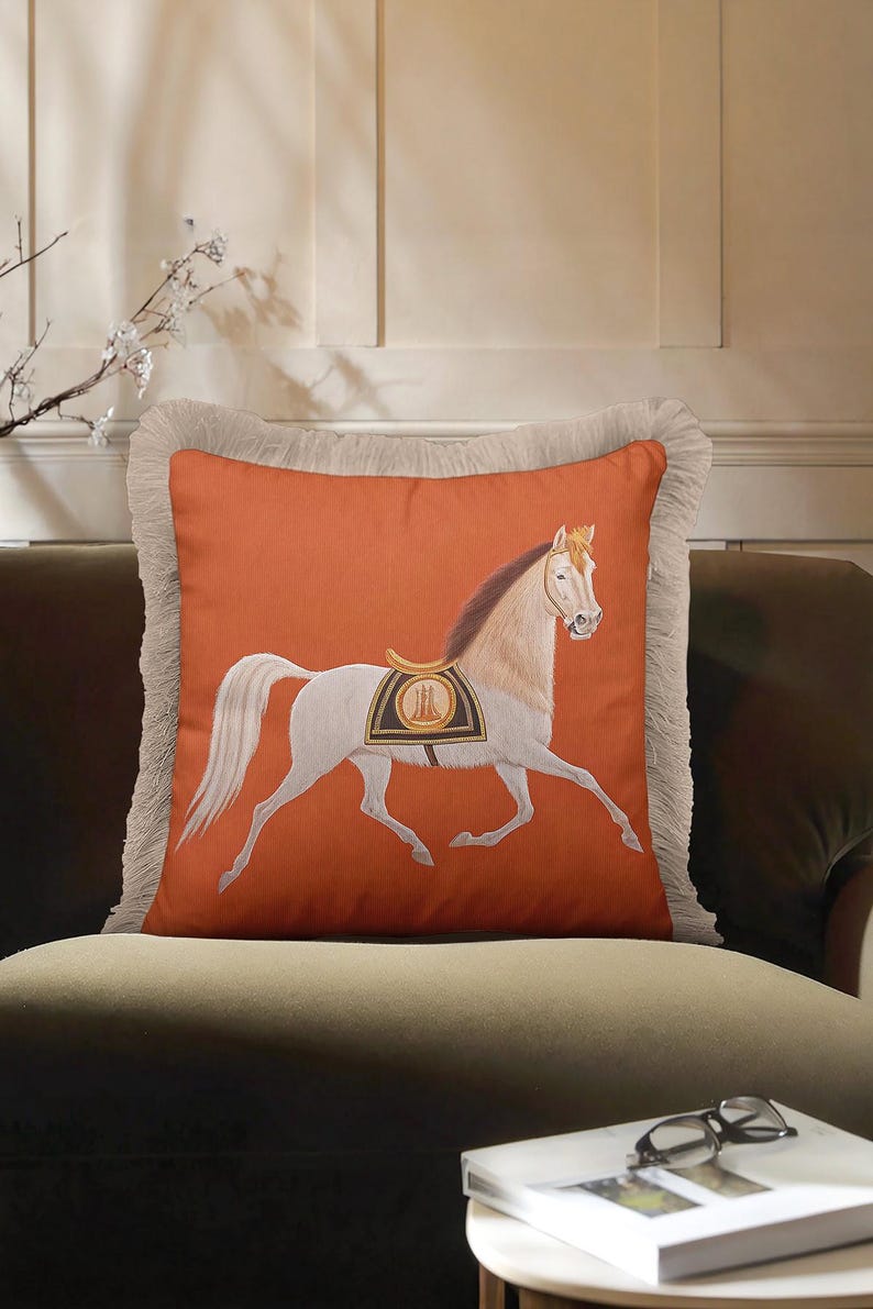 Whether you're a dressage rider or a casual fan, this Horse Art Pillow belongs in your home. It celebrates the beauty and strength of the horse through detailed illustration and elegant design. The fringe detailing mimics the grace of a horse's mane, adding a thematic touch to the pillow's edges. It’s a thoughtful and stylish gift for trainers, riders, or anyone with an equestrian heart.