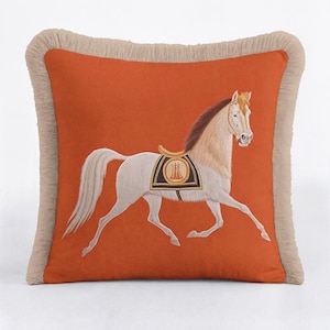 Our Orange Horse Pillow is the perfect addition to your autumn decor collection. The warm terracotta hues reflect the colors of the season, while the horse motif adds a cozy, farmhouse feel. The fringes provide that extra layer of texture needed for a snug reading nook. Transition your home into the colder months with this elegant and inviting equestrian accent piece.