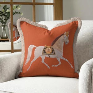 Professional decorators know that texture is key to a beautiful room. Our Tasseled Cushion Cover provides both visual interest and tactile variety. The horse graphic offers a sophisticated "English Manor" look, while the fringe trim breaks up flat surfaces. Use this pillow to layer different styles and create a curated, high-end look in your living room or master bedroom.