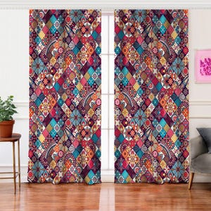 May include: A pair of vibrant, patterned window curtains. The design features a patchwork of colorful diamond shapes with floral and paisley motifs in shades of blue, red, orange, and purple. The curtains are hanging in front of a window, adding a decorative touch to the room.