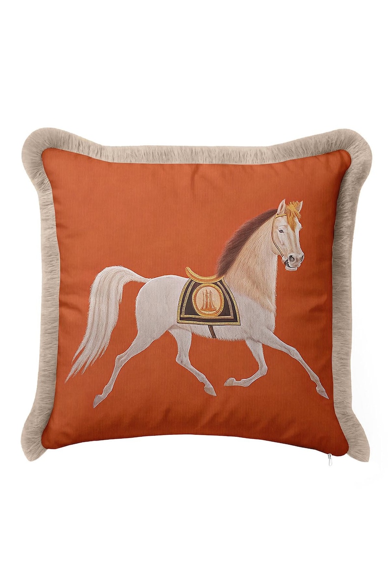 Infuse your space with warmth and energy using our Burnt Orange Decorative Pillow. The bold background color is beautifully offset by a graceful white horse motif and soft cream tassels. Orange is known for creating a welcoming atmosphere, making this fringed cover ideal for guest rooms or entryways. Add a pop of sophisticated color and a touch of classical artistry to your interior design today.