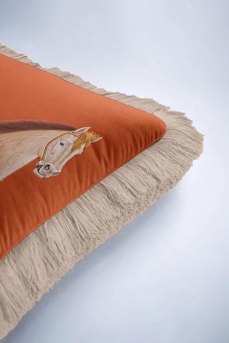 Our fringed covers celebrate the beauty of handmade-style textiles. The tassels are carefully applied to ensure a symmetrical and elegant finish. This attention to detail reflects the quality found in boutique home stores. By choosing this horse-themed pillow, you’re supporting unique designs and bringing a touch of artisan soul into your living space.