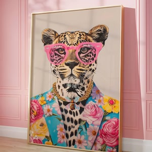 May include: A framed art print featuring a leopard wearing pink sunglasses, a gold necklace, and a floral patterned jacket. The leopard's spots are visible, and a bee pendant hangs from the necklace. The jacket has a blue background with pink and yellow flowers.