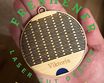 May include: A laser-cut wooden ornament with a circular design. The ornament features a series of parallel lines and the name "Viktoria" engraved on the surface. The word "CUSTOMIZABLE" is at the bottom.