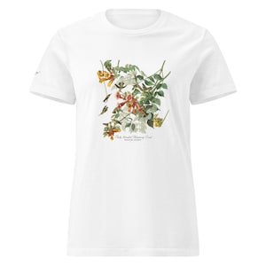 Puede incluir: Una camiseta blanca de manga corta con una ilustración botánica detallada de colibríes y flores en forma de trompeta en tonos naranja, amarillo y verde. El texto debajo de la ilustración dice Ruby-throated Hummingbird, Trochilus colubris.