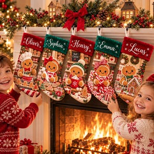 May include: Five personalized Christmas stockings hanging in a row, featuring gingerbread characters and names Oliver, Sophia, Henry, Emma, and Lucas embroidered on the cuffs. The stockings are red and green with festive holiday illustrations.