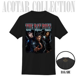May include: Black t-shirt featuring the text "THE BAT BOYS" above an image of three men. The names Azriel, Rhysand, and Cassian are below the text. A smaller image of the back of the shirt is in the lower right corner.
