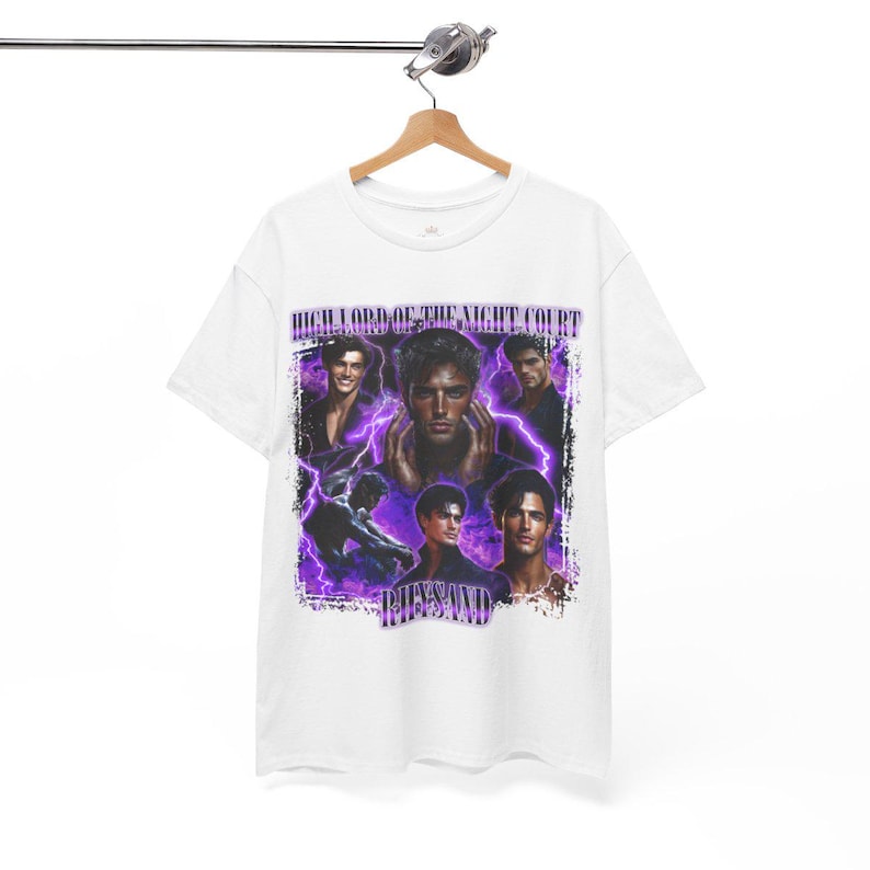 May include: White t-shirt featuring a graphic design with multiple images of a man, purple lightning bolts, and the text "HIGH LORD OF THE NIGHT COURT" and "RHYSAND". The design has a vintage aesthetic.