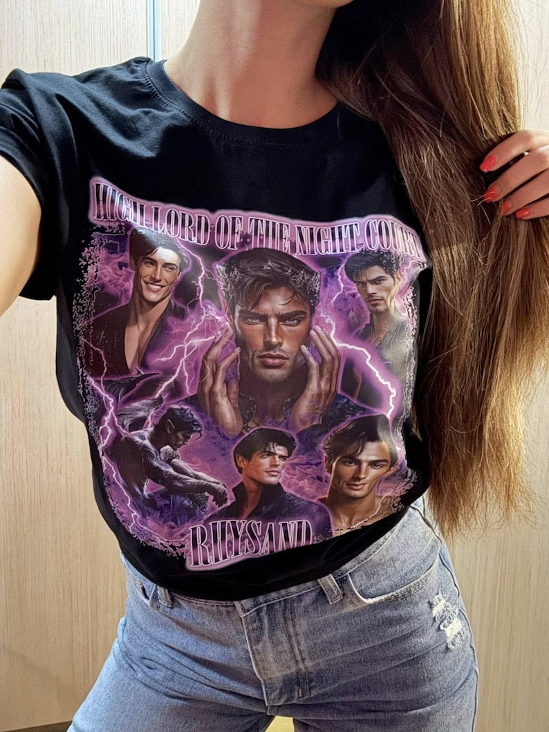 May include: Black t-shirt featuring a graphic design with the text "HIGH LORD OF THE NIGHT COURT" and the name "RHYSAND". The design includes portraits of several men with purple lightning effects.