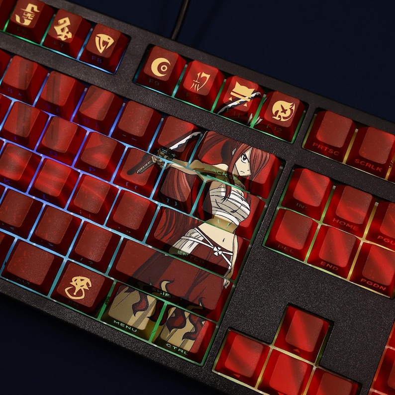 May include: A black mechanical keyboard with red keycaps. Some keycaps feature anime character Erza Scarlet from Fairy Tail. The keyboard has a backlight with a colorful glow.