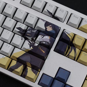 May include: A mechanical keyboard with white keycaps and custom keycaps featuring an anime-style illustration of a female character in a black and white outfit. The keyboard has a silver frame and yellow accent keys.