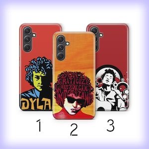 May include: Three rectangular phone cases featuring Bob Dylan graphics. Case 1 is red with a yellow and black portrait and the text DYLAN. Case 2 is orange with a portrait and the text DON'T CRITICIZE WHAT YOU CAN'T UNDERSTAND. Case 3 is red with a black and white portrait.