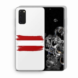 May include: A white smartphone case featuring a horizontal red and white brushstroke design resembling the Austrian flag. The case has a rectangular camera cutout in the top left corner, and the phone screen displays a dark background with bubbles.