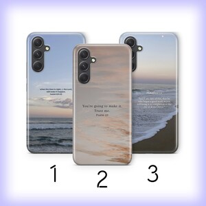 May include: Three smartphone cases featuring scenic designs and printed text. Case 1 shows an ocean view with Isaiah 60:22. Case 2 displays a sandy beach texture with Psalm 23. Case 3 depicts a shoreline at sunset with Philippians 1:6 text printed.