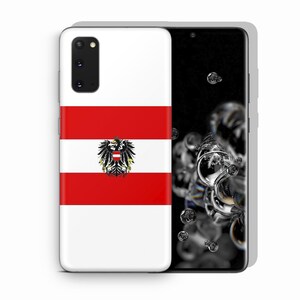 May include: A smartphone case featuring the Austrian flag design with horizontal red and white stripes and a central black eagle emblem. The case has a rectangular camera cutout in the top left corner and covers the back of a black smartphone device.