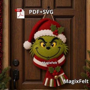 May include: A felt wall hanging featuring a green character with yellow eyes, wearing a red and white Santa hat and a red, white, and green striped scarf with holly accents. The text PDF+SVG and MagixFelt are visible on the design.