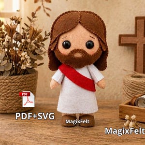 May include: A felt doll depicting a figure with brown hair and a beard, wearing a white robe with a red sash. The doll has black button eyes and brown felt shoes. The text PDF+SVG and MagixFelt are visible near the doll on the surface.