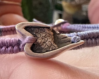 A gorgeous little fine silver angel wing on a beautiful bluey purple leather, cotton and sterling silver friendship bracelet.