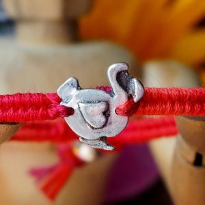 A red leather, cotton and sterling silver friendship bracelet with a lovely handmade fine silver dodo bird charm.