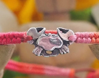 A tiny handmade fine silver crab beautiful deep pinky reds leather, sterling silver and cotton friendship bracelet.