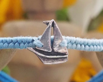 A lovely tiny unique fine silver sailing boat on a gorgeous soft blue leather, cotton and sterling silver friendship bracelet.
