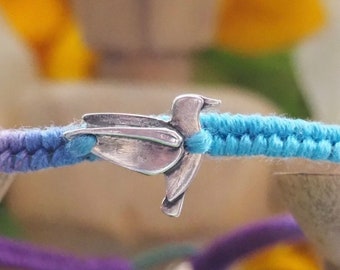 A lovely fine silver humming bird on a cute purple and turquoise leather, sterling silver and cotton friendship bracelet.