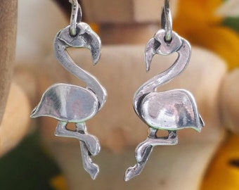 An gorgeous pair of handmade fine silver flamingo earrings hung on sterling silver wires...