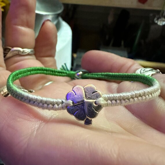 A beautiful green leather, cotton and sterling silver friendship bracelet  with a fine silver shamrock four leaf
