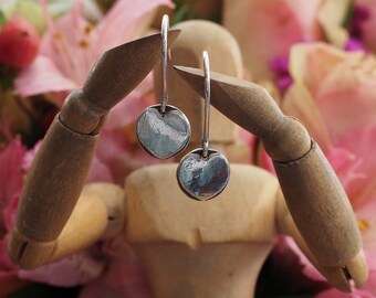 A pair of simple little heart earrings handmade in fine silver on handmade sterling silver wires.