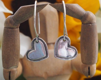 A pair of simple little heart earrings handmade in fine silver on handmade sterling silver wires.