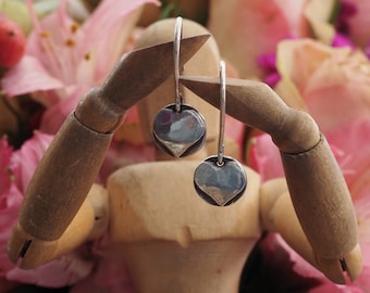 A pair of simple little heart earrings handmade in fine silver on handmade sterling silver wires.