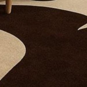May include: Close-up of a modern area rug with a brown and beige abstract design. The rug features a flowing, organic pattern in contrasting colors, creating a visually interesting texture. The rug is made of a soft material.