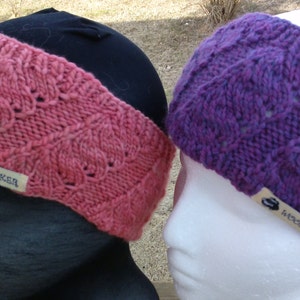May include: Two knitted headbands in pink and purple with a white label that says "Wooly Hooker".