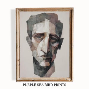 May include: Framed abstract portrait print. The artwork depicts a geometric face in shades of grey, brown, and white. The text "PURPLE SEA BIRD PRINTS" is printed at the bottom of the frame.
