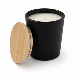 May include: A matte black cylindrical candle vessel filled with white wax and a centered wick, accompanied by a round, light-colored bamboo lid featuring a clear silicone seal ring positioned to the left of the container.