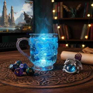 May include: A clear glass mug with a dragon design, filled with blue liquid and emitting a blue glow. A silver dragon figurine with a blue gem sits nearby, along with several dice. The mug has a decorative handle.