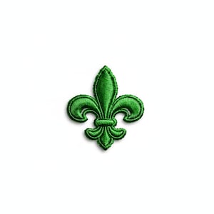 May include: A green embroidered fleur-de-lis patch. The patch features a detailed design with a three-petal motif and a textured appearance. The patch is a vibrant shade of green and is set against a white background.