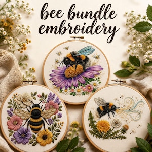 May include: Three embroidered bee-themed hoops. The top hoop features two bees on a purple flower. The bottom left hoop has a large bee surrounded by flowers. The bottom right hoop shows a bee blowing out dandelion seeds. The text "bee bundle embroidery" is at the top.