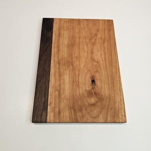 May include: A handmade wooden sign with the text "Welcome" in a playful font. The sign features a distressed white background and a dark brown border, perfect for a front door or entryway. Measures approximately 12 inches wide.