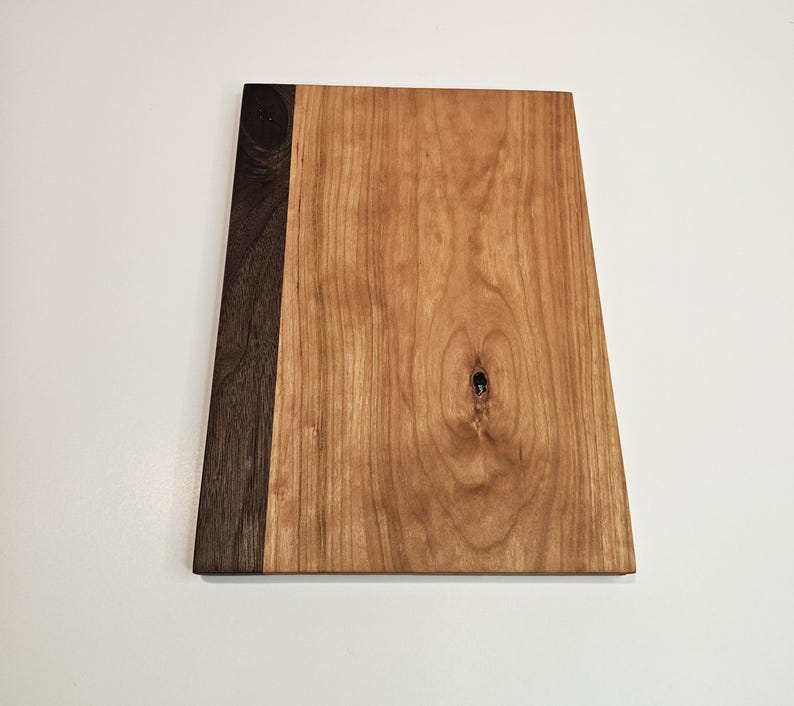 May include: A handmade wooden sign with the text "Welcome" in a playful font. The sign features a distressed white background and a dark brown border, perfect for a front door or entryway. Measures approximately 12 inches wide.
