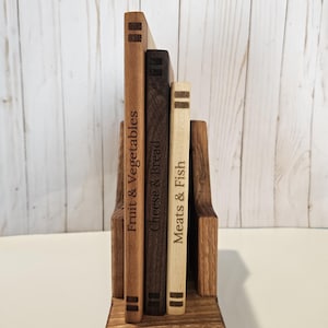 May include: A set of three ceramic mugs with a speckled, matte finish. The mugs are in shades of cream, light gray, and dark gray. Each mug has a simple, minimalist design and a rounded handle. The mugs are stacked on top of each other.