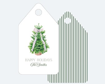 May include: Gift tags with a watercolor illustration of a Christmas tree adorned with a white bow and ribbon. The tag reads "Happy Holidays" and "The Smiths" in elegant script. The reverse side features green and white vertical stripes.