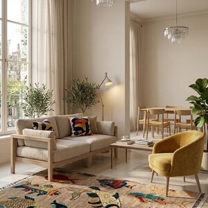 May include: A rectangular area rug featuring a beige background with a colourful pattern of various fish in shades of blue, orange, red, and green. The rug has a fringed edge with multi-coloured threads and is placed in a living room setting.