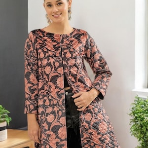 May include: A long, open-front coat with a floral pattern in shades of black and peach. The coat features a quilted design and three-quarter length sleeves. The coat is knee-length and has a classic, elegant style.